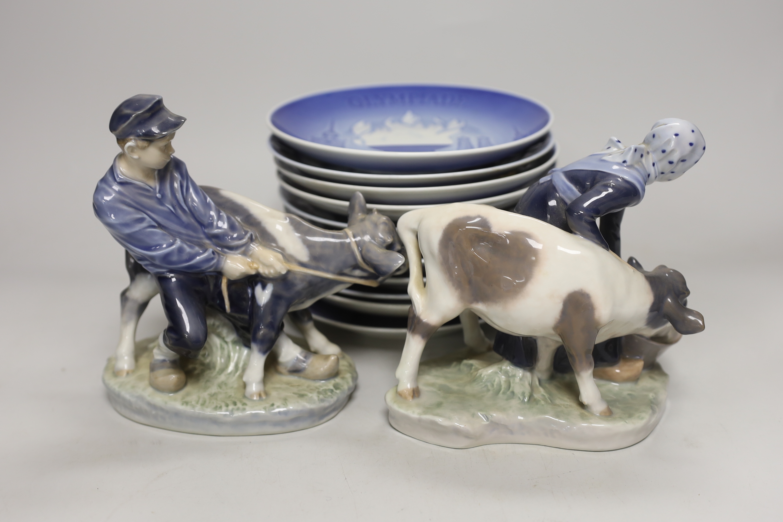 A pair of Royal Copenhagen porcelain figures and assorted commemorative plates, tallest figure 17cm high